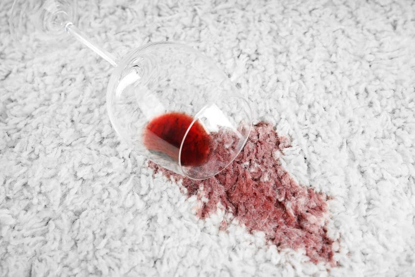 A glass of wine is on the floor.