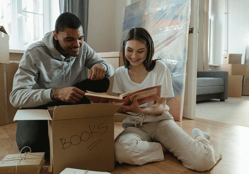 Untitled-1 copy A man and woman sitting on the floor reading books.