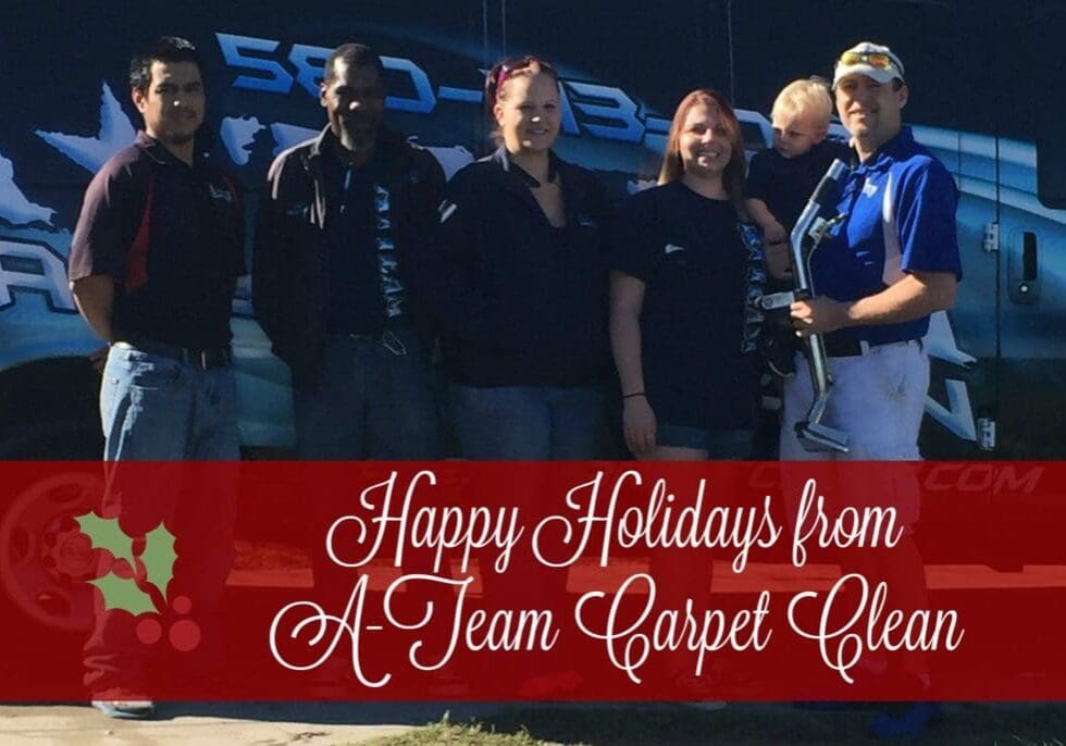 A team carpet cleaning team posing for a picture.