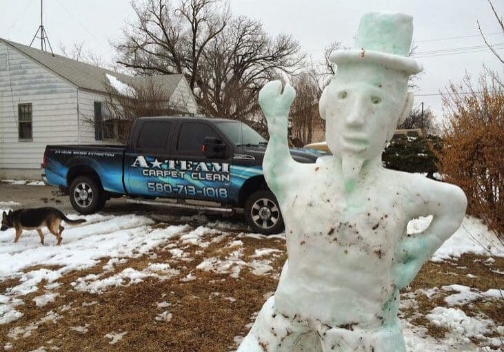 A statue of a man in top hat and tie.